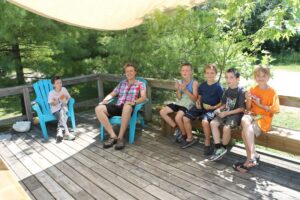 Group of youg campers on the deck with staff member